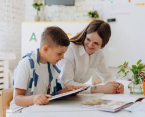 boy reading with adult