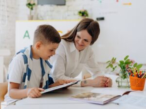boy reading with adult