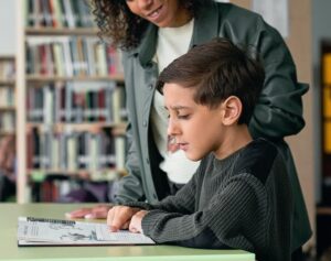 guided reading student with teacher